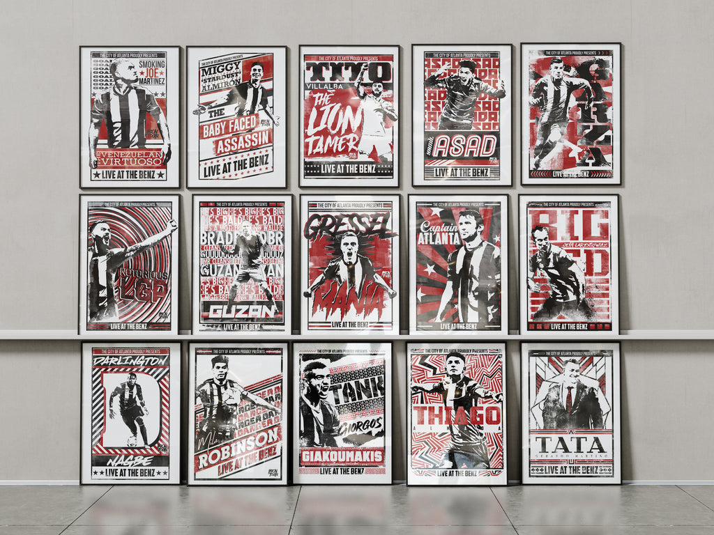 Collection of framed posters on a wall with a neutral background