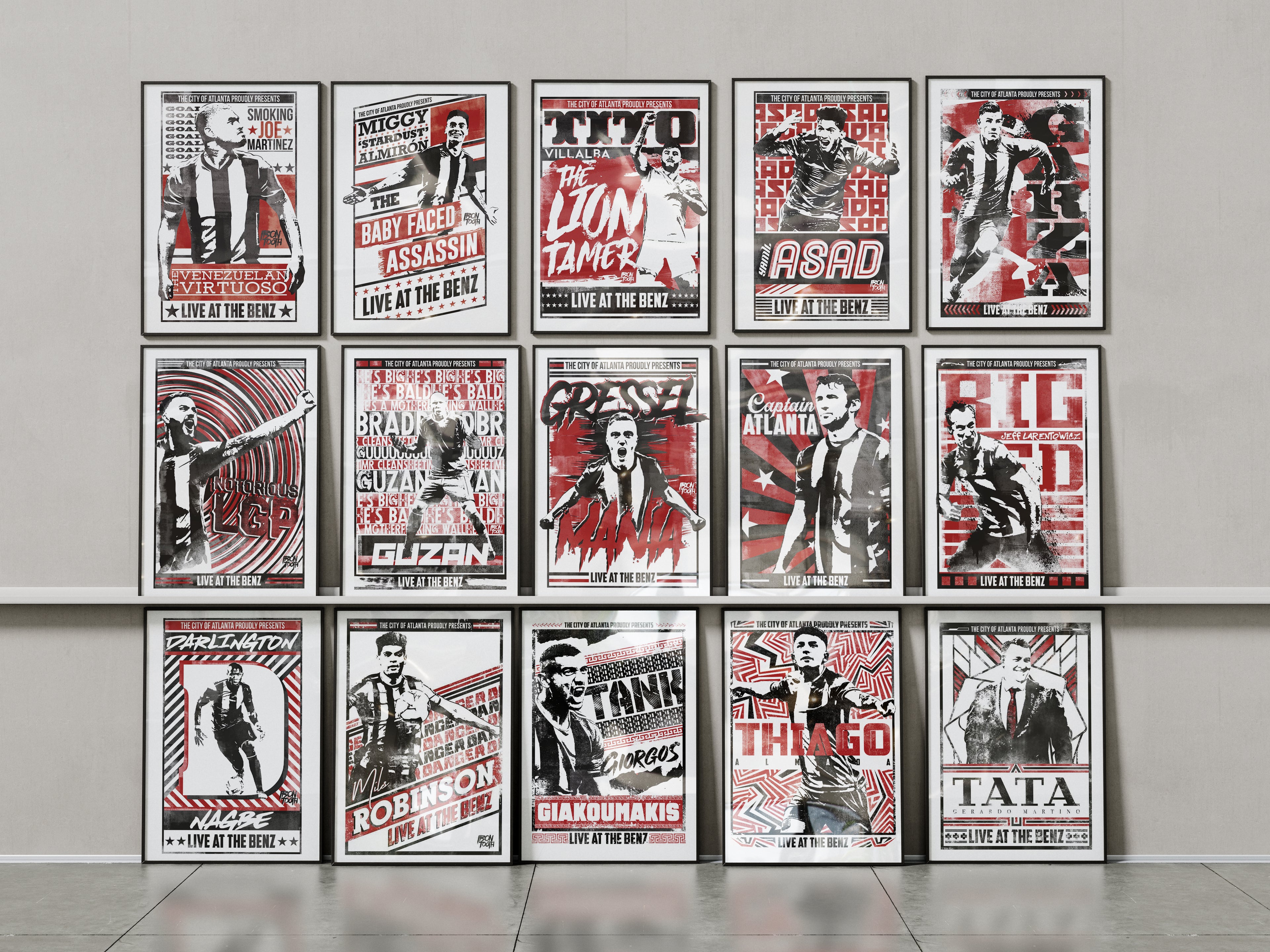 Collection of framed posters on a wall with a neutral background